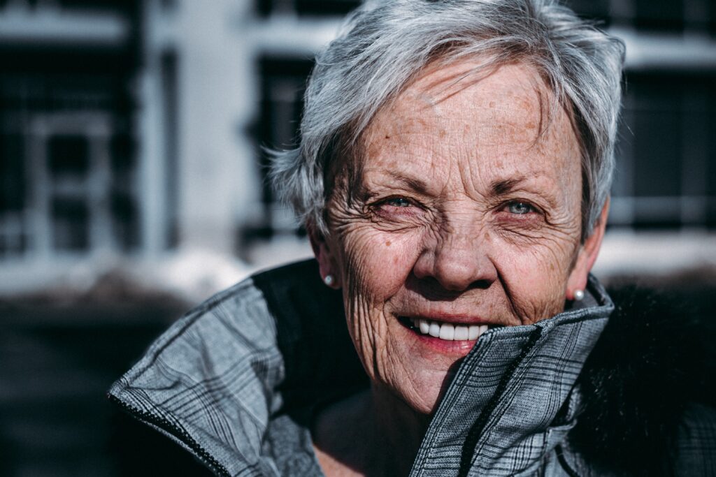 a woman with grey hair smiling