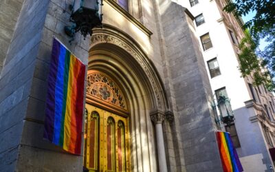 church doors with rainbow banners